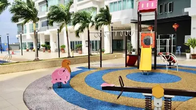 a playground in front of a building with palm trees at \u7a3b\u5cb8 DaoAn Homestay-with balcony in Sekincan