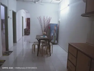 a kitchen with a table and chairs in a room at Homestay Bajet EM2 Pantai Remis 3 Room in Pantai Remis