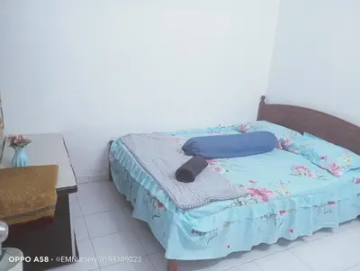 a bedroom with a bed with a blue comforter at Homestay Bajet EM2 Pantai Remis 3 Room in Pantai Remis