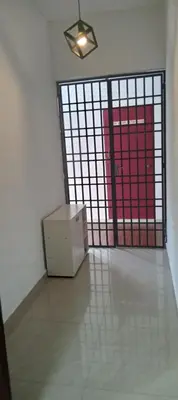 a room with a door with a box in front of it at Risma Homestay in Batu Ferringhi