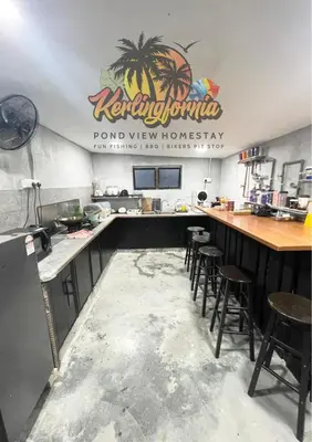 a kitchen with a bar and stools in a restaurant at Kerlingfornia Pond View Homestay and Farmstead in Kerling