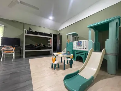 a play room with a slide and a bunk bed at Kerlingfornia Pond View Homestay and Farmstead in Kerling