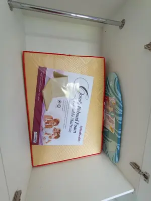 a book and a pair of shoes in a closet at Radif Homestay Seri Iskandar#1 in Kampong Bota Road