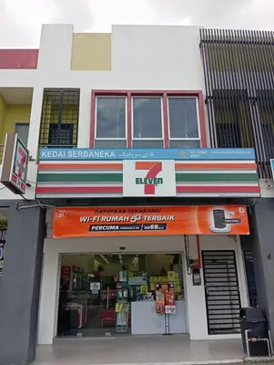 a store front of a building with an orange sign at Radif Homestay Seri Iskandar#1 in Kampong Bota Road