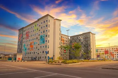 a large building with colorful windows in a parking lot at Radif Homestay Seri Iskandar#1 in Kampong Bota Road