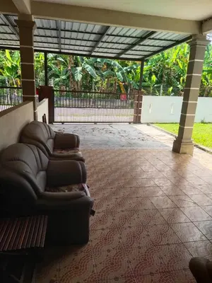 a couch sitting in the middle of a patio at Teratak Desa Cemerlang 1