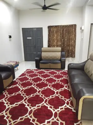 a living room with a couch and a rug at Teratak Desa Cemerlang 1