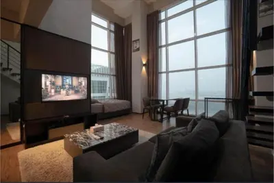 a living room with a couch and a flat screen tv at Maritime suite Karpal sign sea view in George Town