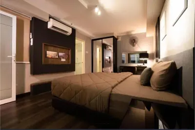 a bedroom with a bed and a desk in it at Maritime suite Karpal sign sea view in George Town