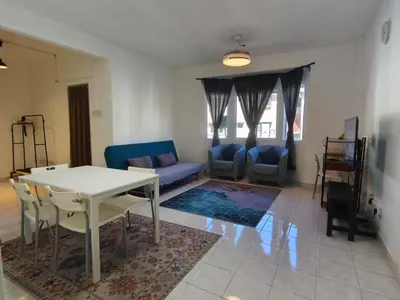 a living room with a white table and chairs at Puncak Cameron Holiday in Cameron Highlands