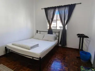 a bed in a room with a window at Puncak Cameron Holiday in Cameron Highlands