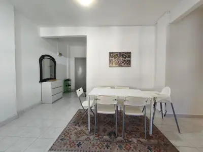 a dining room with a white table and white chairs at Puncak Cameron Holiday in Cameron Highlands