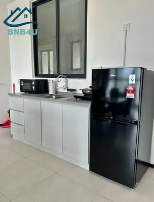 a kitchen with a black refrigerator and a sink at Urban Suites Apartment In Jelutong George Town in George Town