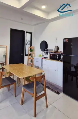 a kitchen with a wooden table and some chairs at Urban Suites Apartment In Jelutong George Town in George Town