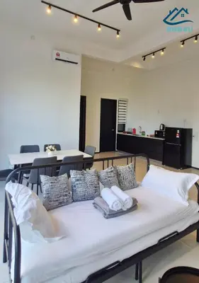 a bed with pillows on it in a room at Urban Suites Apartment In Jelutong George Town in George Town