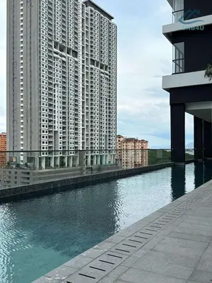 a body of water with tall buildings and buildings at Urban Suites Apartment In Jelutong George Town in George Town