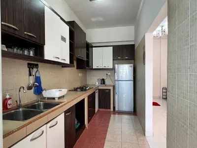 a kitchen with a sink and a refrigerator at Highland Breze Homestay in Tanah Rata