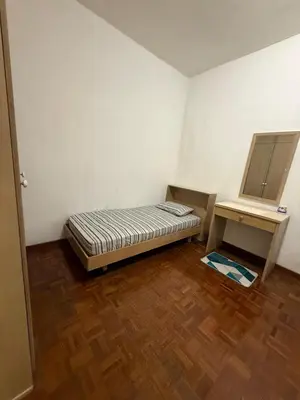 a small room with a bed and a desk at Haven Nine Homestay in Batu Ferringhi