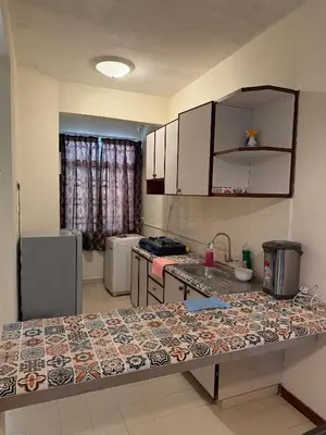 a kitchen with a counter top in a room at Haven Nine Homestay in Batu Ferringhi