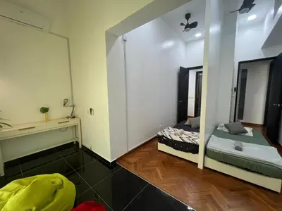 a small room with a bed and a mirror at Marina Chic l Stylish 2BR Retreat l Straits Quay in Tanjung Bungah