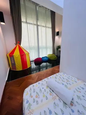 a bedroom with a bed and a window withools at Marina Chic l Stylish 2BR Retreat l Straits Quay in Tanjung Bungah