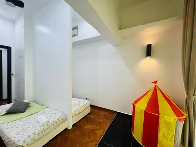 a room with two beds and a tent in it at Marina Chic l Stylish 2BR Retreat l Straits Quay in Tanjung Bungah