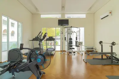 a gym with several exercise equipment in a room at Marina Chic l Stylish 2BR Retreat l Straits Quay in Tanjung Bungah