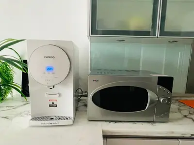 a microwave and a blender sitting on a counter at Marina Chic l Stylish 2BR Retreat l Straits Quay in Tanjung Bungah