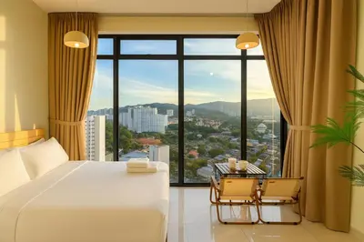 a hotel room with a bed and a table with chairs at \u3010Lux\u3011HighFloor wi SunSet | Infinity Pool | KTV 207 in George Town
