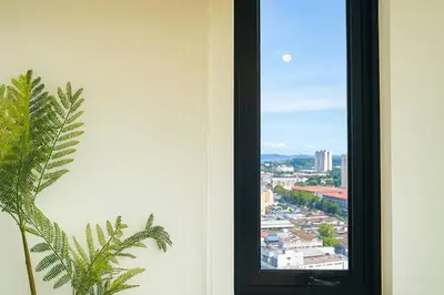 a window with a view of a city at \u3010Lux\u3011HighFloor wi SunSet | Infinity Pool | KTV 207 in George Town