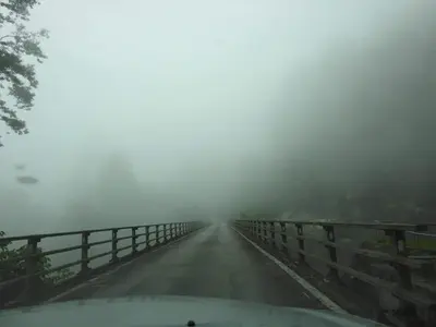 a car driving on a road in the fog at A356 Silverpark Resort lifted unit 5th floor in Bukit Fraser
