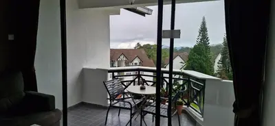 a balcony with a table and chairs on a balcony at A356 Silverpark Resort lifted unit 5th floor in Bukit Fraser