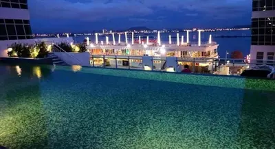 a swimming pool on top of a building at night at \u3010SeaView\u3011High Floor 2BR Duplex SeaFront-Town 21 in George Town