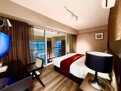 a hotel room with a bed and a desk and a window at \u3010SeaView\u3011High Floor 2BR Duplex SeaFront-Town 21 in George Town
