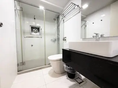 a bathroom with a sink and a toilet and a shower at \u3010SeaView\u3011High Floor 2BR Duplex SeaFront-Town 20 in George Town