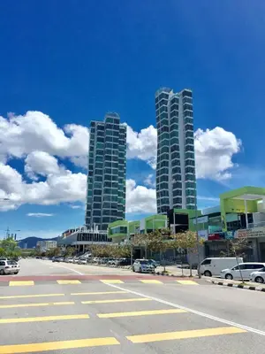two tall buildings with cars parked in a parking lot at \u3010SeaView\u3011High Floor 2BR Duplex SeaFront-Town 20 in George Town