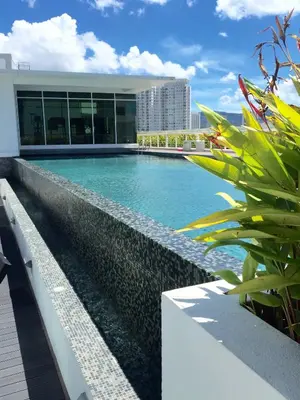 a swimming pool on the side of a building at \u3010SeaView\u3011High Floor 2BR Duplex SeaFront-Town 20 in George Town
