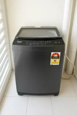 a black washing machine sitting on a floor at \u3010SeaView\u3011High Floor 2BR Duplex SeaFront-Town 20 in George Town
