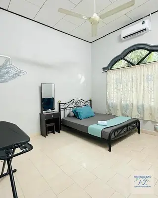 a bedroom with a bed and a tv and a window at Homestay AZ Padang Serai in Padang Serai