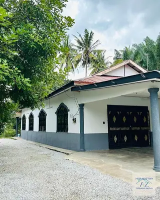 a white building with a gate in front of it at Homestay AZ Padang Serai in Padang Serai