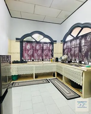 a kitchen with two windows and a counter top at Homestay AZ Padang Serai in Padang Serai