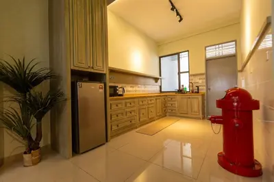 a kitchen with a red fire hydrant in the middle at #15mins walk to Kea Farm#4bedrooms4bathrooms#10pax in Brinchang