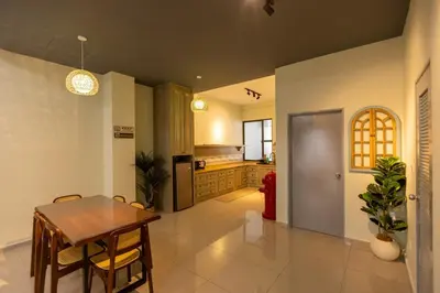 a kitchen with a table and a dining room at #15mins walk to Kea Farm#4bedrooms4bathrooms#10pax in Brinchang