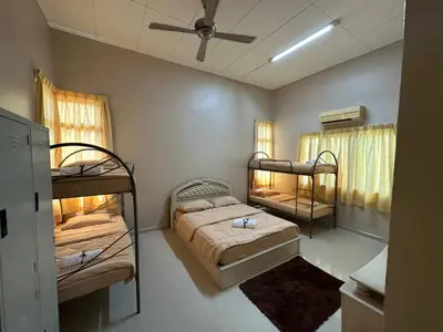 a bedroom with two bunk beds and a ceiling at GS Homestay Whole Villa in Gertak Sanggul
