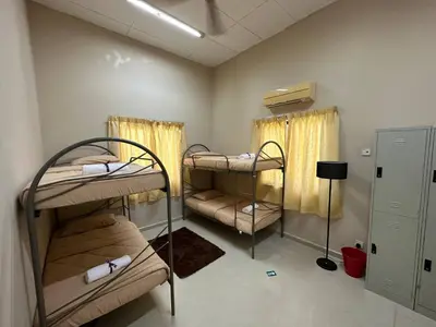 a room with three bunk beds in it at GS Homestay Whole Villa in Gertak Sanggul