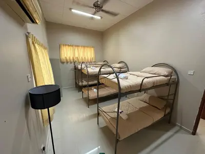 a room with four bunk beds in a room at GS Homestay Whole Villa in Gertak Sanggul