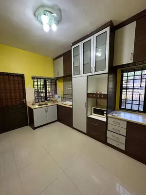 a large kitchen with wooden cabinets and white appliances at GS Homestay Whole Villa in Gertak Sanggul