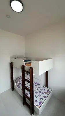 a room with two bunk beds and a table at Teratak Burung Darimi in Kampong Bota Road
