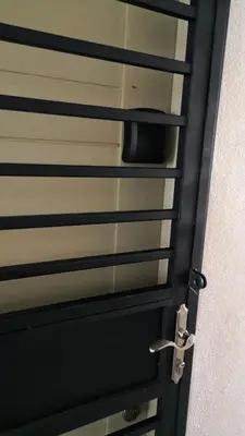 a black door with a window and a handle at Teratak Burung Darimi in Kampong Bota Road
