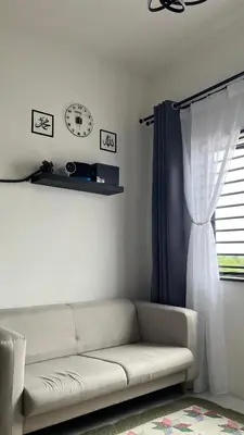 a living room with a couch and a window at Teratak Burung Darimi in Kampong Bota Road